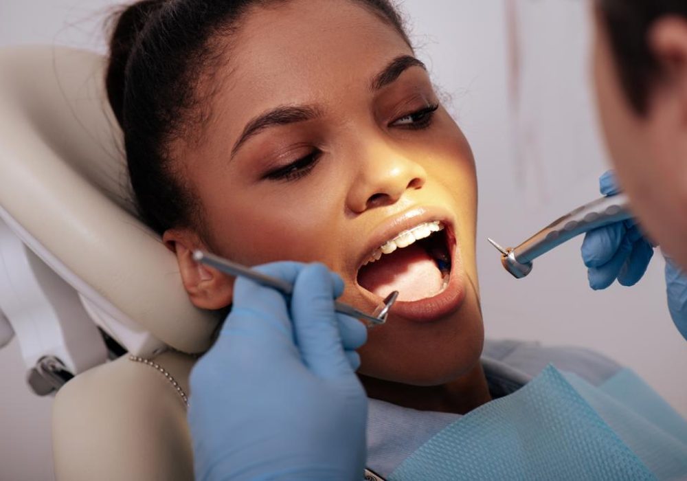 stock-photo-selective-focus-dentist-latex-gloves-holding-dental-instruments-attractive-african